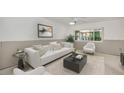 Cozy living room featuring a comfortable white sofa, decorative pillows, and stylish decor at 1660 Cape Ann Ne Ave # 2, St Petersburg, FL 33702