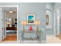 Stylish foyer with decorative table, lamps, and view into adjacent office at 17921 Arbor Haven Dr, Tampa, FL 33647