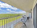 A covered balcony with outdoor seating offers peaceful views at 19451 Gulf Blvd # 205, Indian Shores, FL 33785