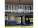 View of building entrance showing signage for Bay Shores Yacht & Tennis Club at 19451 Gulf Blvd # 205, Indian Shores, FL 33785