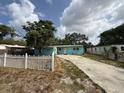 Charming single-story home featuring a light blue exterior, white trim, and a concrete driveway at 2175 20Th Sw Ave, Largo, FL 33774
