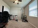 Bedroom set up as workout space with ceiling fan and a window with blinds at 219 Lovely Ct, Plant City, FL 33566