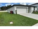 Well maintained home with a two car garage and green lawn at 219 Lovely Ct, Plant City, FL 33566