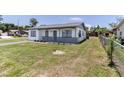 Charming home with well-kept lawn and a long driveway on a sunny day at 2425 Wishing Well Cir, Tampa, FL 33619
