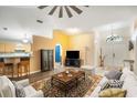 Bright living room with a high ceiling, ceiling fan, hardwood floors and an ornate area rug at 24841 Mary Beth Ct, Land O Lakes, FL 34639