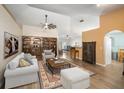 Cozy living room featuring hardwood floors, bookshelves and a ceiling fan at 24841 Mary Beth Ct, Land O Lakes, FL 34639