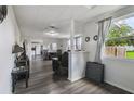 Open-concept living area featuring modern flooring, neutral colors, and abundant natural light from large windows at 2607 N 59Th St, Tampa, FL 33619