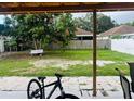 Spacious backyard with mature trees, a bench, and a patio area, perfect for outdoor enjoyment at 2610 W Powhatan Ave, Tampa, FL 33614