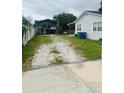 Long gravel driveway leading to a covered parking area, offering ample space at 2610 W Powhatan Ave, Tampa, FL 33614