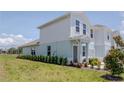 Side view of a well-maintained townhome with a long row of shrubbery at 3062 Victoria Inlet Dr, Holiday, FL 34691