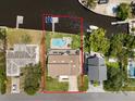 Aerial view of waterfront property with pool, dock, and outdoor dining, providing a serene backyard oasis at 316 Hillpoint Dr, Palm Harbor, FL 34683