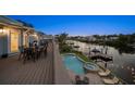 Waterfront home boasts an inviting pool, a raised spa, and an outdoor dining area with serene water views at 316 Hillpoint Dr, Palm Harbor, FL 34683