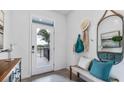Inviting entryway with a white door, stylish decor, tiled floor, and a view to the outside at 32417 Welling Blade Loop, Wesley Chapel, FL 33545
