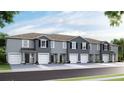Townhome exteriors featuring a neutral color palette, individual garages, and well-maintained landscaping at 32417 Welling Blade Loop, Wesley Chapel, FL 33545