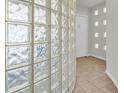 Bright hallway with unique glass block wall and tiled floors at 3412 W San Juan St # A, Tampa, FL 33629
