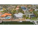 Waterfront property with a dock, screened-in enclosure, manicured lawn, and located on a canal at 3830 46Th S Ave, St Petersburg, FL 33711