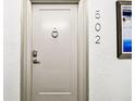 The front door to unit 502 with door knocker and modern lock at 400 Island Way # 502, Clearwater Beach, FL 33767
