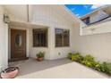 Charming front entrance with a decorative door, complemented by neatly trimmed greenery and neutral color tones at 440 Lakeview Dr # 34, Palm Harbor, FL 34683