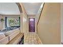Inviting entryway featuring tile floors, a staircase, and a view into the spacious living area at 4612 E Seneca Ave, Tampa, FL 33617