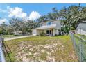 This two-story home boasts stone accents, a well-maintained yard, mature trees, and a fenced-in yard at 4612 E Seneca Ave, Tampa, FL 33617