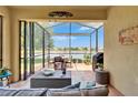 Beautiful screened lanai featuring outdoor seating and serene lake views at 5422 Sunset Falls Dr, Apollo Beach, FL 33572