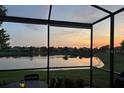 Water view from screened in lanai during sunset at 5422 Sunset Falls Dr, Apollo Beach, FL 33572
