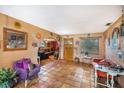Inviting living room with terracotta flooring, eclectic decor, and comfortable seating for relaxing and entertaining at 5643 86Th N Ave, Pinellas Park, FL 33782