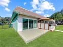 Backyard with spacious deck and manicured lawn, perfect for outdoor entertaining with its private, serene setting at 599 Westwinds Dr # 9, Palm Harbor, FL 34683