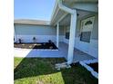 Covered front porch with tidy landscaping and a welcoming front entrance with stylish exterior paint at 6008 Firefly Ln, Apollo Beach, FL 33572