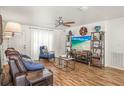 Inviting living room with wood floors, fan, and a comfortable seating arrangement with natural light at 630 Mac Crillus Rd, Largo, FL 33770