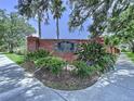 Community entrance featuring brick signage amidst lush foliage, creating a welcoming atmosphere at 6314 Gondola Dr, Riverview, FL 33578