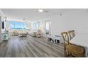 Bright living room with modern décor and a large window showcasing ocean views at 6372 Palma Del Mar S Blvd # 601, St Petersburg, FL 33715