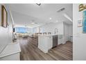 Bright, open floor plan with hardwood floors connecting the kitchen to the expansive living room at 6372 Palma Del Mar S Blvd # 601, St Petersburg, FL 33715