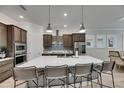 Modern kitchen with a large center island, stainless steel appliances, and pendant lighting at 7420 Paradiso Dr, Apollo Beach, FL 33572