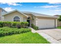 Charming single-story home with a well-manicured lawn and attached two-car garage at 899 Addison Ne Dr, St Petersburg, FL 33716