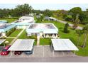 Aerial view of a residential community with well-kept lawns and assigned parking at 101 Cambridge Trl # 194, Sun City Center, FL 33573