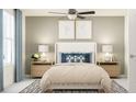 Cozy bedroom with a queen bed, bedside tables, lamps and a ceiling fan, creating a relaxing retreat at 10211 Trumpet Honeysuckle Way, San Antonio, FL 33576