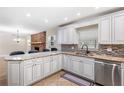 Bright kitchen featuring granite countertops, mosaic backsplash, and stainless steel appliances at 11029 Clay Pit Rd, Tampa, FL 33610