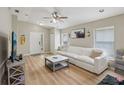 Comfortable living room featuring a white sofa, a ceiling fan, and plenty of natural light at 11708 Crest Creek Dr, Riverview, FL 33569