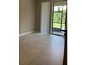 Dining room with tile flooring and sliding glass door leading to the outside at 11901 Castine St, New Port Richey, FL 34654