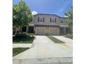 Exterior view of a townhome showcasing a two-car garage and well-maintained lawn at 11901 Castine St, New Port Richey, FL 34654