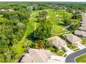 Aerial view showcasing the home, golf course, and surrounding lush greenery at 12134 Tournament View Ave, New Port Richey, FL 34654