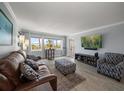 Bright living room featuring large windows with water views and stylish furnishings at 1230 Gulf Blvd # 304, Clearwater, FL 33767