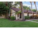 Charming single-story home featuring lush landscaping and a welcoming entrance at 1380 Azalea Dr # 1701, Dunedin, FL 34698