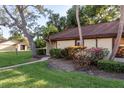 Well-maintained exterior with lush landscaping and a charming walkway leading to the entrance at 1380 Azalea Dr # 1701, Dunedin, FL 34698