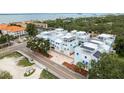 Scenic aerial view of light blue townhomes, showcasing meticulous landscaping and convenient parking at 1413 Bayshore Blvd # 11, Dunedin, FL 34698
