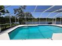 Sparkling screened-in pool with picturesque views of the adjacent lake at 16502 Windsor Park Dr, Lutz, FL 33549