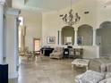 Spacious living room with high ceilings, chandelier, columns and tile floors at 17942 Villa Creek Dr # 17942, Tampa, FL 33647