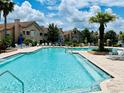 Resort-style pool with ample seating, lush landscaping, and sunny skies at 17942 Villa Creek Dr # 17942, Tampa, FL 33647