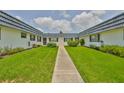 Neat condos feature symmetrical designs and well-manicured lawns, creating an inviting outdoor space at 301 Kings Blvd # 130, Sun City Center, FL 33573